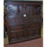 An early 18c oak court cupboard with carved panels.