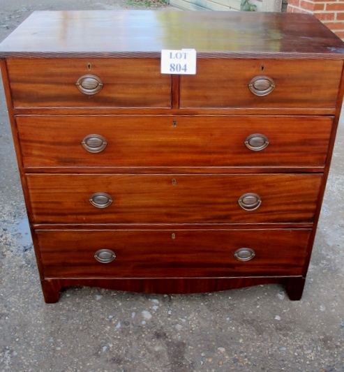 A Georgian mahogany chest of two short over three long drawers with brass oval handles and bracket