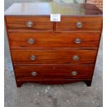 A Georgian mahogany chest of two short over three long drawers with brass oval handles and bracket