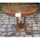 A Victorian figured walnut demi lune turn over card table with ornate base (slightly a/f) est: