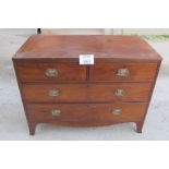 A George III mahogany chest of two short over two long drawers with brass handles and bracket feet