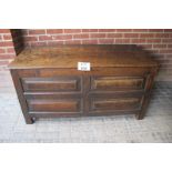An 18c oak coffer with a four section panelled front est: £200-£400