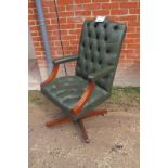 A 20c green deep buttoned swivel desk chair est: £30-£50