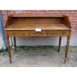 A George III desk with raised back over three short drawers and turned legs est: £150-£300