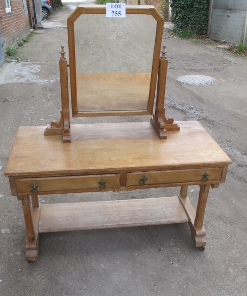 A Gothic revival pale oak dressing table with swivel mirror over two drawers est: £100-£150