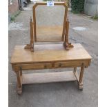 A Gothic revival pale oak dressing table with swivel mirror over two drawers est: £100-£150