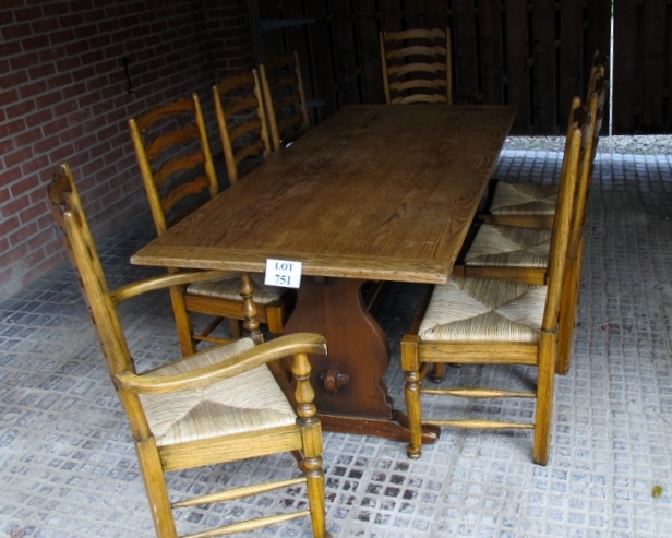 A 20c oak refectory dining table and eight oak ladder back chairs with rush seats and in good