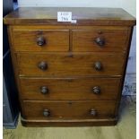 A Victorian mahogany chest of two short over three long drawers with turned handles and bun feet