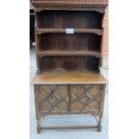 A 19c oak dresser with panelled plate rack above two geometric doors est: £100-£150