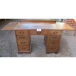 A c1900 oak/walnut writing desk with end drop leaves and nine drawers est: £200-£400