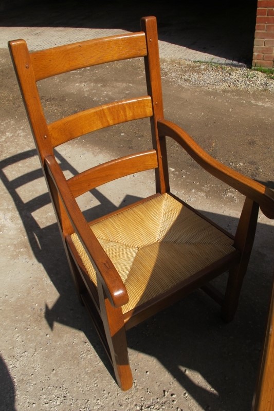 A late 20c pale oak dining table with six matching chairs all with rush seats and to include two - Image 3 of 3