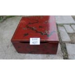 A red lacquered box with pull out front depicting birds on branches est: £30-£50