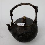 A Chinese bronze teapot all over decorat