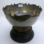 A silver punch bowl with wooden stand Ch