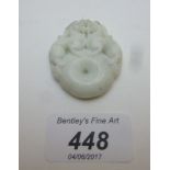 A Chinese white jade pendant with carvin