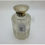 A heavy cut glass scent bottle with silv