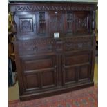 An early 18c oak court cupboard with car