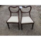 A pair of Victorian balloon back chairs