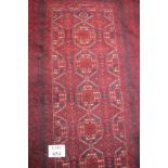 A 20c Persian rug on deep red ground (92