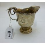 A small silver cream jug with double scr