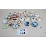 A collection of 24 porcelain pill boxes