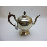 A silver pedestal teapot with hardwood h