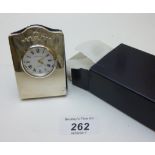 A small silver fronted clock with applie