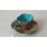 A Majolica cup and saucer est: £15-£25 (