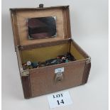 A ladies travelling case containing loads of old bottles,