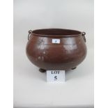 A large copper cauldron on claw feet (26 cm high x 40 cm wide approx) est: £30-£40 (A4)