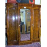 A superb Victorian c1860 figured walnut triple wardrobe with central mirrored door,