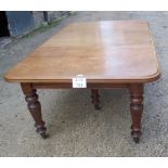 A Victorian mahogany D end dining table with one extra leaf over turned legs and casters est: