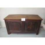 An early 19c oak coffer with carved panels to front beneath later top est: £100-£150