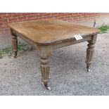 A pale oak wind out dining table with reeded legs and china casters (c1870-1880) est: £150-£250