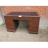 A 19c oak pedestal desk with black leather top over nine drawers in need of some attention est: