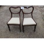 A pair of Victorian balloon back chairs with cream upholstered drop in seats in clean condition