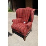 A late 20c chunky winged armchair upholstered in red check material est: £150-£250