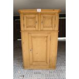 A Victorian pine two sectioned cupboard with two cupboard doors over a central door est: £200-£400