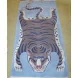 A 20c wool rug depicting a tiger (180 x