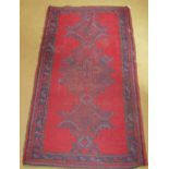 A small Persian rug on red ground (94 cm