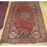 A 20c Persian rug on red ground (slight