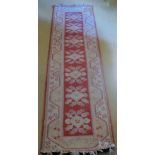 A 20c cream ground runner with pink and