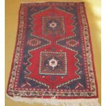 A Persian wool rug red, blue and cream (