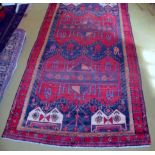 A fine Baluchi carpet on red ground (310 x 152 cm approx) est: £150-£250