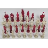 A 19c Cantonese ivory chess set (one knight missing) each piece stands on ivory puzzle balls