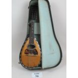 A cased mandolin est: £30-£50 (A4)