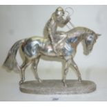 A large silver model of a race horse and