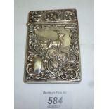 A silver embossed card case decorated wi