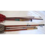 Four old fishing rods in canvas cases es