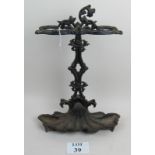 An ornate Victorian style cast iron stick stand, two large vintage wooden serving boards,